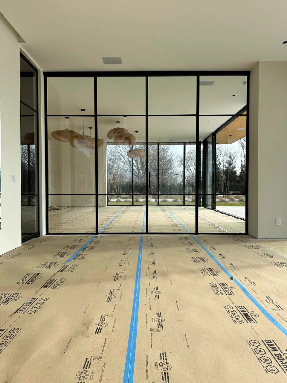 Completed double-sliding black matte glass partition, Water Mill NY estate — WiseGlass NY