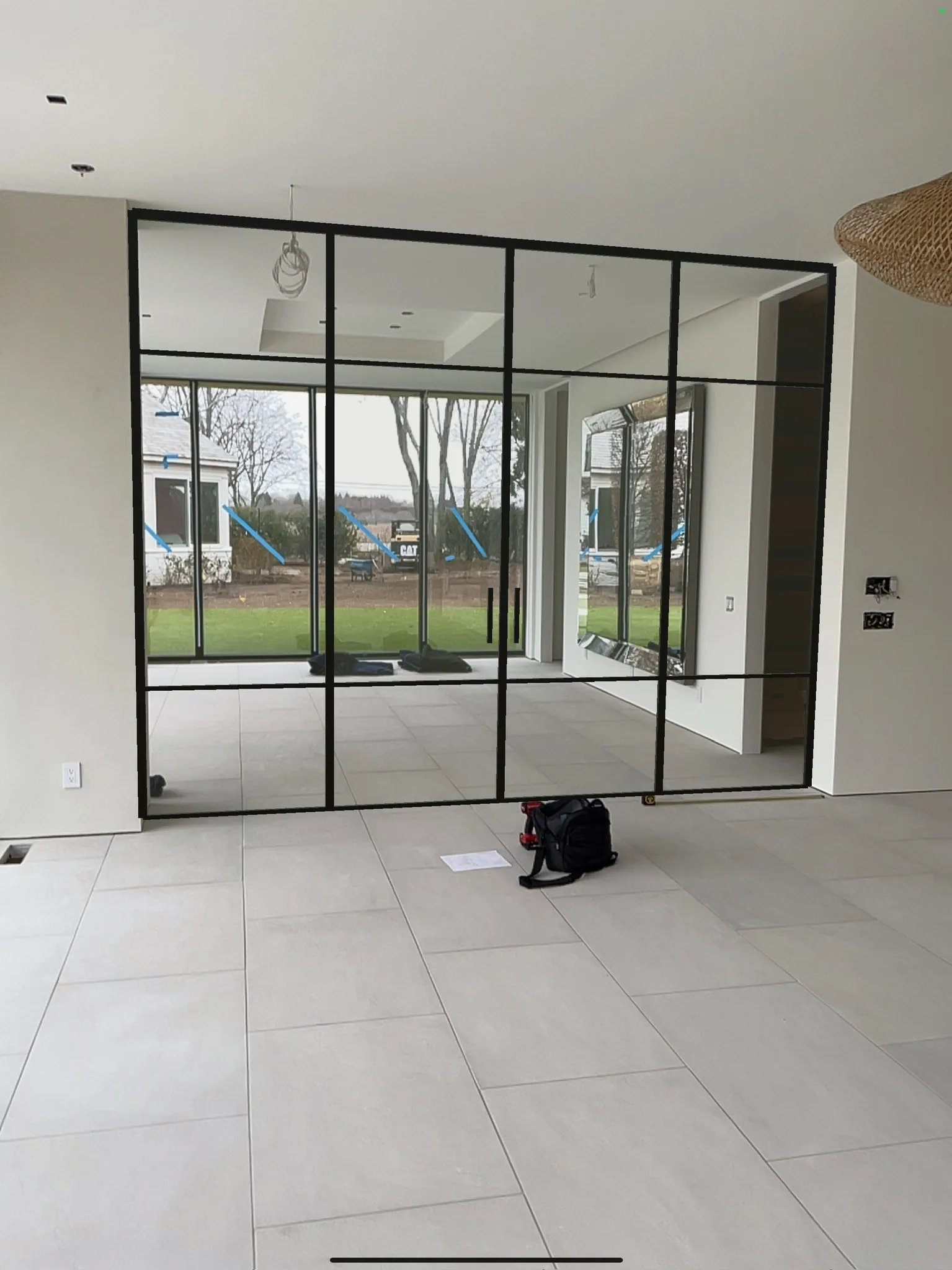 Day of installation — black matte glass partition at Water Mill NY estate before floors were laid, WiseGlass NY
