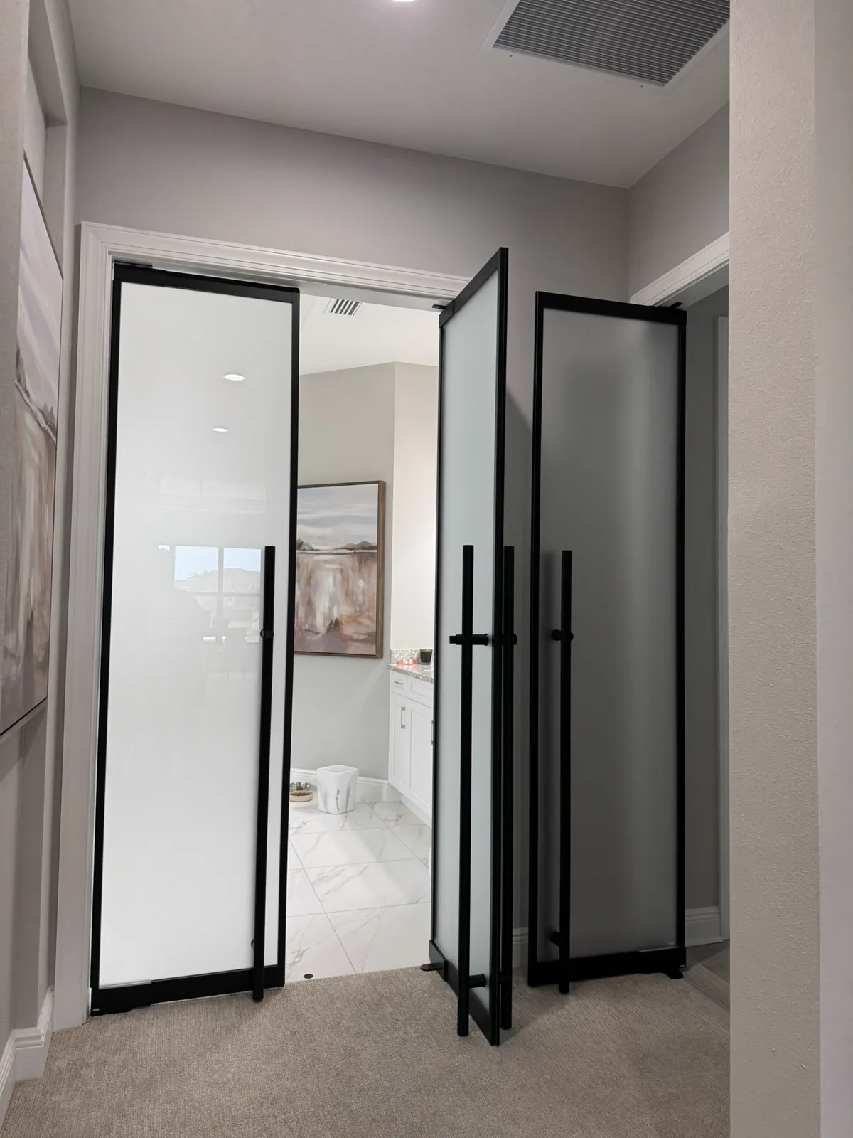 Custom frosted glass bi-fold doors in black matte aluminum frame — WiseGlass NY